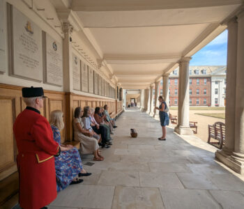 A group sit in the ground of Royal Hospital Chelsea