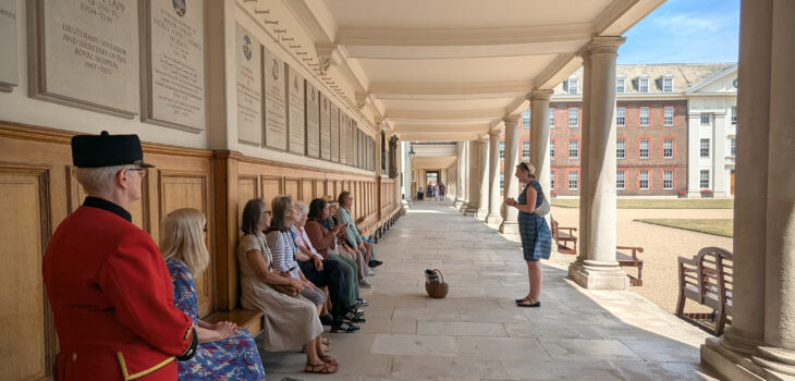 A group sit in the ground of Royal Hospital Chelsea